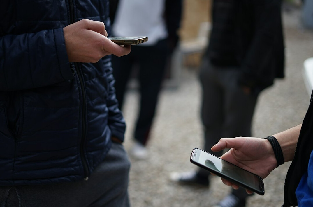 people using smartphones in public