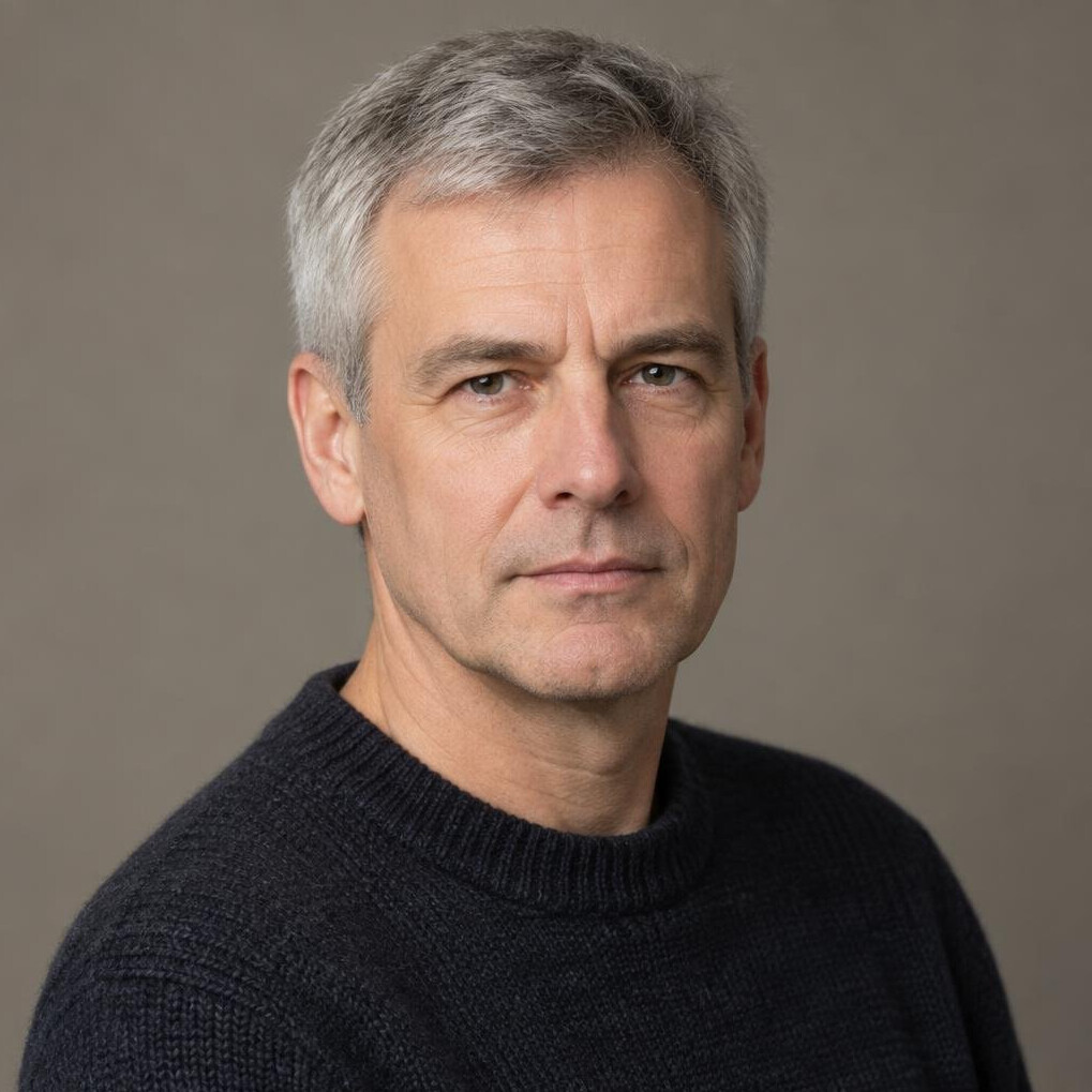 Studio portrait of a German man in a knit sweater